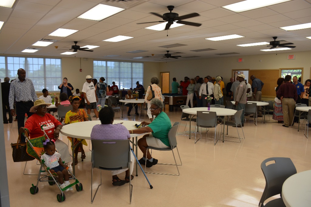 Visitors to the Rubonia Community Center inside the primary meeting space, with some standing and others seated at roundtables.