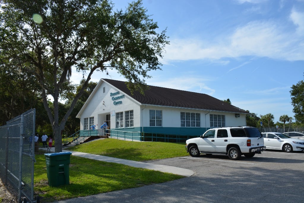 Outdoor view of the Rubonia community Center, with two white cars parked in the parking lot.